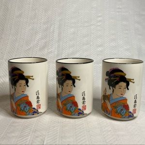 Three Asian tea cups with geisha girl.